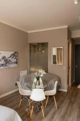 a living room with a table and a couch at Menlyn Maine Gem in Pretoria