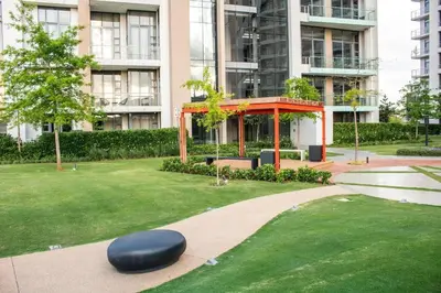 a large building with a green yard with a black ottoman at Menlyn Maine Gem in Pretoria
