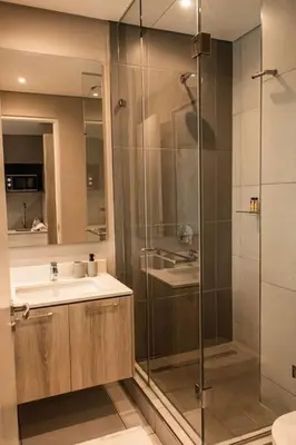 a bathroom with a shower and a sink at Menlyn Maine Gem in Pretoria