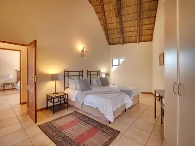 a bedroom with a large bed in a room at Luxurious 4 Bedroom Villa 94 in Mabula