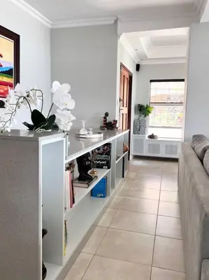 a living room with a couch and a table at The Windsor- Hartbeespoort Dam in Hartbeespoort