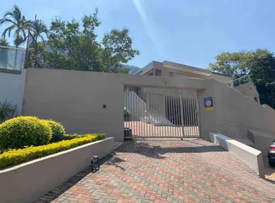 a house with a gate and a brick driveway at The Windsor- Hartbeespoort Dam in Hartbeespoort