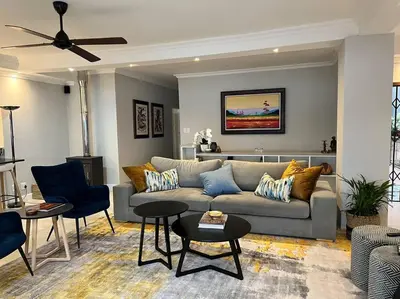 a living room with a couch and chairs at The Windsor- Hartbeespoort Dam in Hartbeespoort