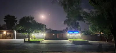 a parking lot with a sign that says exit from a garage at East Park Inn in Polokwane