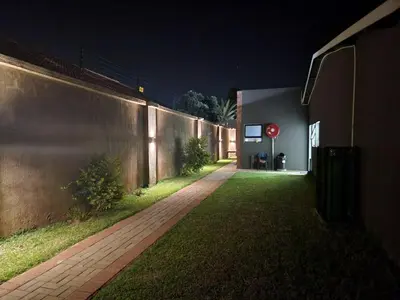 a stop sign on the side of a building at night at East Park Inn in Polokwane