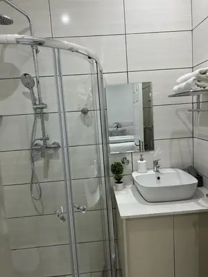 a bathroom with a shower and a sink at Beevap Guesthouse in Pretoria