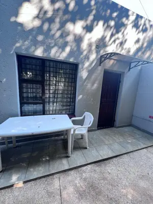 a white bench sitting next to a building at Beevap Guesthouse in Pretoria
