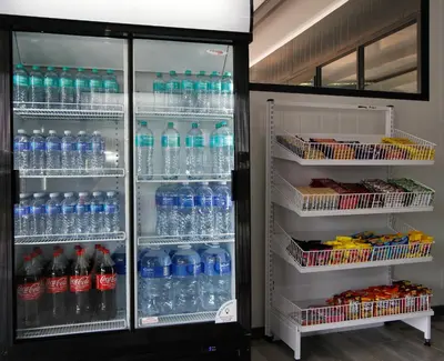 a refrigerator filled with lots of bottles of water at SleepOver Phabeni in Hazyview