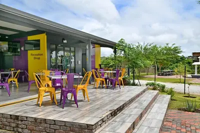 a deck with colorful tables and chairs on it at SleepOver Phabeni in Hazyview
