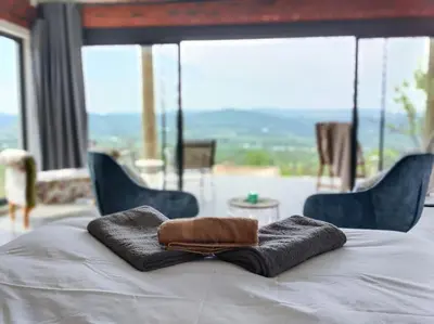 a pair of towels sitting on top of a bed at Rocky Road Mountain Lodge in Pretoria
