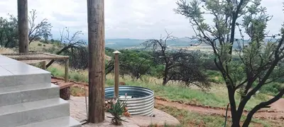 a barrel sitting on the ground next to a pole at Rocky Road Mountain Lodge in Pretoria