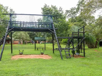 a swing set in a park with a playground at 26 on Greenway in White River