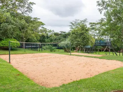 a sand volleyball court in a park with trees at 26 on Greenway in White River