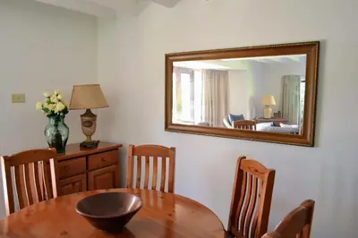 a dining room with a table and a mirror at Eagles Nest in Dullstroom