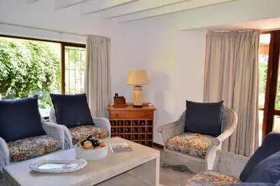 a living room with two chairs and a coffee table at Eagles Nest in Dullstroom