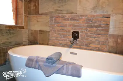 a bath tub with a towel sitting on top of it at Eagles Nest in Dullstroom