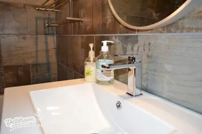 a bathroom sink with two soap bottles on it at Eagles Nest in Dullstroom