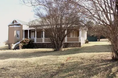 a white house with trees in front of it at BlesBok House in Erasmus