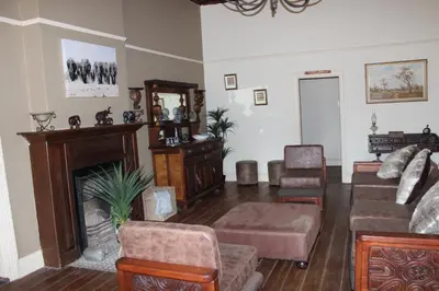 a living room filled with furniture and a fireplace at BlesBok House in Erasmus