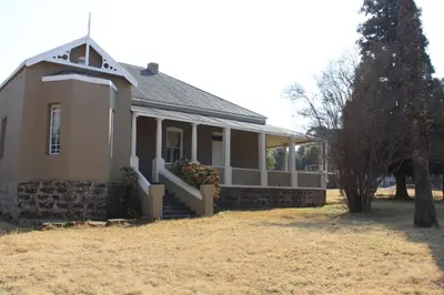 a small house with a porch and a tree at BlesBok House in Erasmus