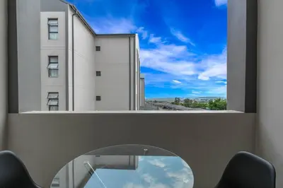 a glass table with a view of a building at Smart Apartment 17 in Erand