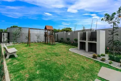 a garden with a bench and a building at Smart Apartment 17 in Erand