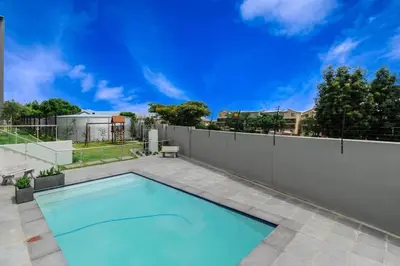 a swimming pool in a backyard with a fence at Smart Apartment 17 in Erand