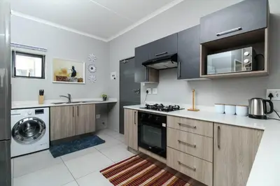 a kitchen with a sink and a stove top oven at Smart Apartment 17 in Erand