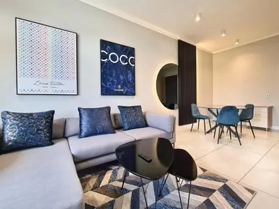 a living room with a couch and a table at 11 Floors in the Sky - Luxurious 1 Bedroom in Pretoria