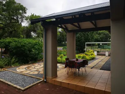 a patio with a table and chairs under a pavilion at Cozy Manor Guestrooms in Lyttelton