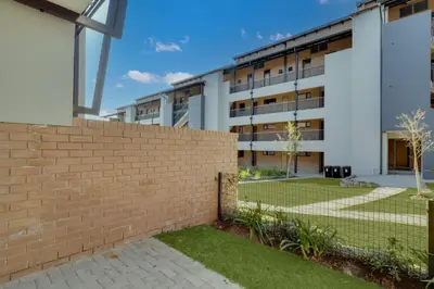 a brick wall in front of a building at The Lillies Luxury Apartment in Midrand
