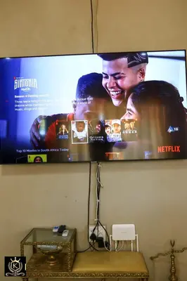 a flat screen tv hanging on a wall at KO'THABENG GUESTHOUSE in Lebowakgomo