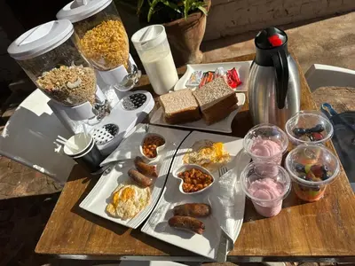 a table topped with plates of food on a table at KO'THABENG GUESTHOUSE in Lebowakgomo
