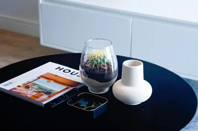 a table with a vase and a plant in a glass at Executive Apartment at Ellipse Waterfall in Midrand