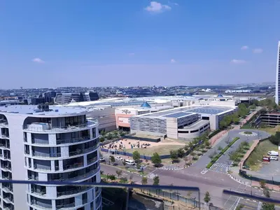 an aerial view of a city with a tall building at Executive Apartment at Ellipse Waterfall in Midrand