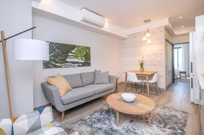 a living room with a couch and a table at The Regency Cozy Apartment- 629 in Pretoria