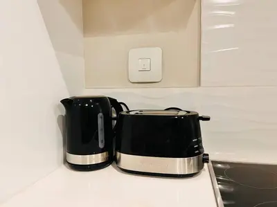 a black and silver toaster sitting on top of a counter at The Regency Cozy Apartment- 629 in Pretoria