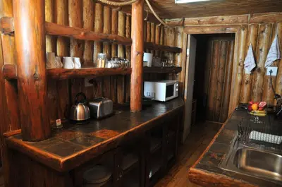 a kitchen with a counter with a microwave and a sink at On Golden Pond - Mount Amanzi in Hartbeespoort