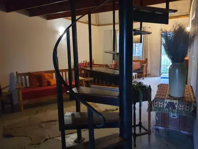 a living room with a couch and a table at KatiKati Eco Lodge in White River