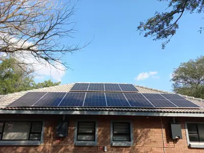 a house with solar panels on the roof at Make a memory in Marloth Park