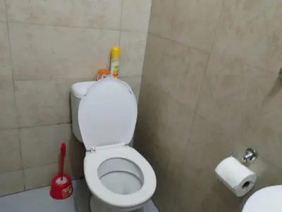 a bathroom with a white toilet in a stall at The Rose Guesthouse in Witbank