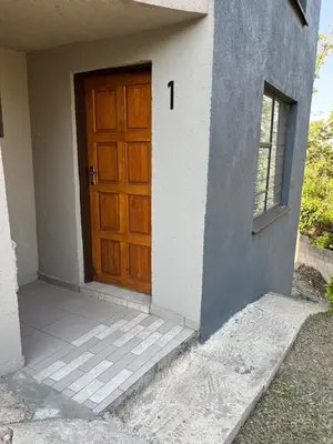 a wooden door on the side of a house at Mlakalaka Guesthouse in KuMcogwaba