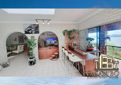 a kitchen and dining room with a table and chairs at Va sabi bo, Best View, Luxury Family Villa in Hartbeespoort Dam in Hartbeespoort