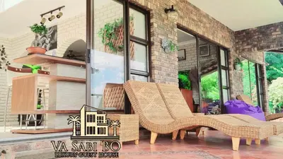 a couple of chairs sitting in front of a building at Va sabi bo, Best View, Luxury Family Villa in Hartbeespoort Dam in Hartbeespoort