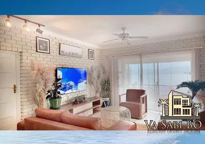 a living room with a couch and a chair at Va sabi bo, Best View, Luxury Family Villa in Hartbeespoort Dam in Hartbeespoort