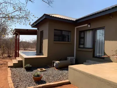 a small house with a pathway leading to it at African Olive in Hoedspruit