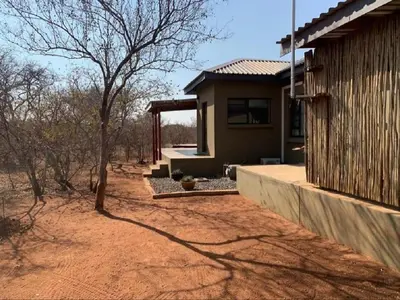 a small house in the middle of a field at African Olive in Hoedspruit