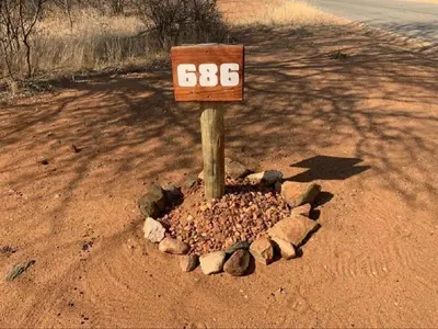 a sign in the middle of a dirt road at African Olive in Hoedspruit
