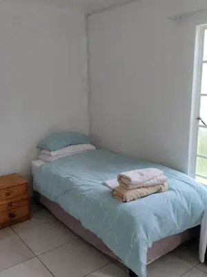 a bedroom with a bed with towels on it at Outside room in Pretoria