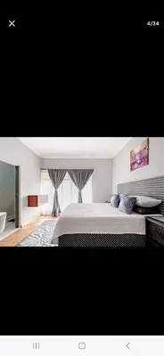 a bedroom with a large bed and a window at Black Owl Lodge in Kempton Park